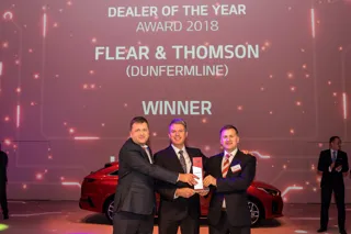Flear and Thomson’s Scott Buchanan collects the group's 'dealer of the year' award from Paul Philpott, president and chief executive of Kia Motors UK