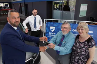 Paul Couchman General Sales Manager (left) hands the keys to their new car over to first customers Trevor and Jean Clarke, watched by General Manager (second left) Matthew Jones
