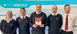 The team at Drayton Motors proudly display their Best UK Dealerships to Work For awards