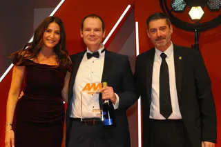 Arran Bangham, group vice-chairman,  RRG Škoda, accepts the award from Darren  Preddy, director – dealer sales, Rapid RTC, right and host Lisa Snowdon, left