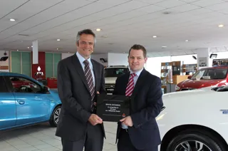 Toby Marshall, marketing director at Mitsubishi Motors in the UK, presents the long-service award to Chris Green, CCR Motor Co regional general manager