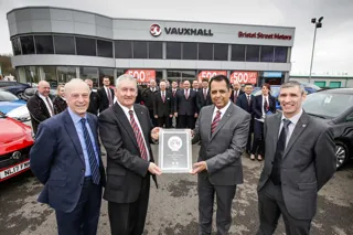 Everlasting Love: John Watchman (centre left) receives an award in recognition of his service from Jass Singh, general manager at Bristol Street Motors Vauxhall Sunderland