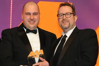 Darren Bradford, general manager, Drayton Motors, collects the  award from Martin Peters, sales director, Autoclenz Group, right
