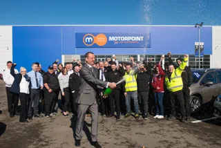 Jason Hurt, Motorpoint Sheffield general manager pops champagne at the new site