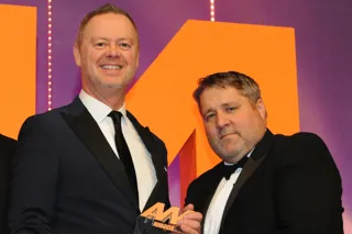 Martin Sewell, managing  director, Rockar, collects the  award from Nathan Elliott,  head of sales, Autino, right
