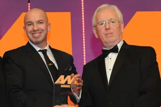 Nathan Tomlinson, managing director, Devonshire Motors, collects the award from  Richard Lailey, director, Autoguard Warranties, right