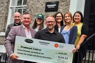 Paul Keighley, PK Motors' managing director, hands over a cheque for over £11,000 to Dan Appleby and members of the fundraising team at Drummond Central 
