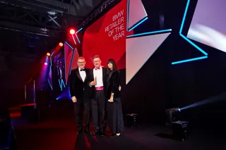 BMW UK chief executive Graeme Grieve (left) presents the Retailer of the Year award to Nigel Marsh, head of business at Sytner Sheffield, with event host Claudia Winkleman