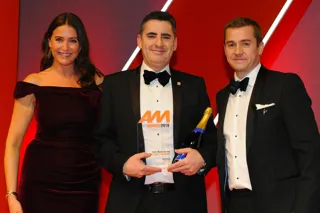 Russell Borrie, group franchise director, Arnold Clark Automobiles,  accepts the award from Richard Jones, managing director – motor  finance and leasing, Lloyds Banking Group, right, and host Lisa Snowdon, left
