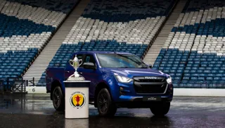A image of an Isuzu pick-up truck in a football stadium with the Scottish Cup trophy