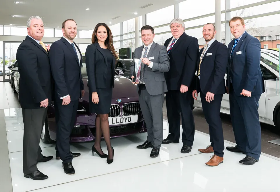 Mark Powell, head of business at Lloyd BMW Blackpool, pictured with the BMW Retailer of the Year award, alongside staff