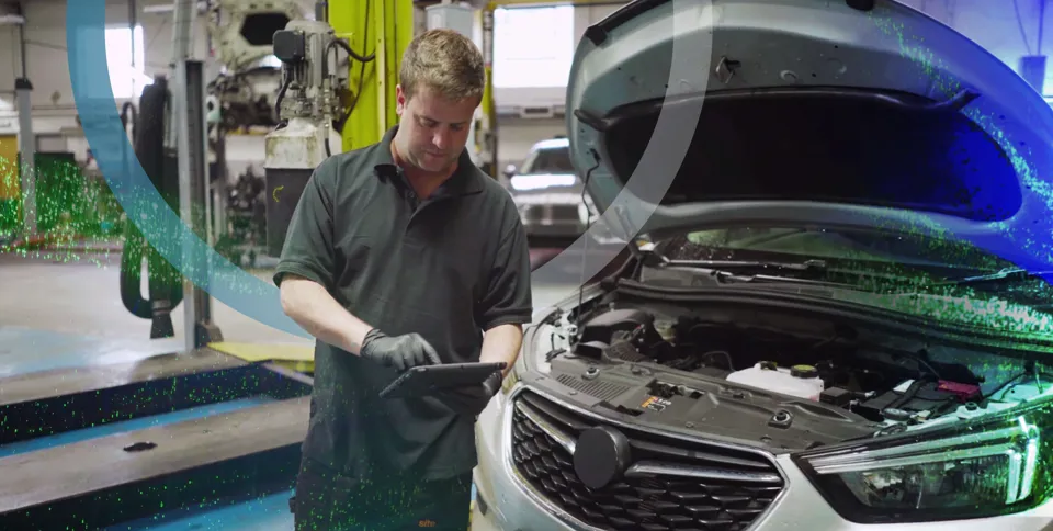 Technician working on car in a workshop