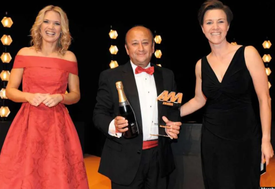 Marshall Motor Group CEO Daksh Gupta receives the award from heycar chief commercial officer Karen Hilton