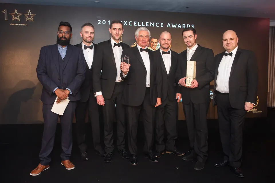 J & A Rigbye & Sons employees celebrate their awards hat-trick at the annual Citroën dealer awards alongside comedian and host Romesh Ranganathan