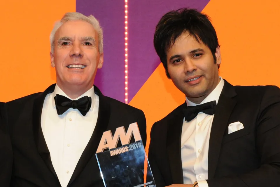 Dale Wyatt, director automobile,  Suzuki GB, collects the award from Khusro Kamal, chief executive, Car Finance Giant, right