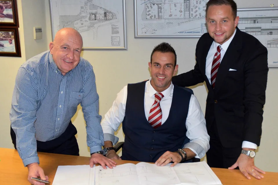 New signing (from left): Chorley Group chairman Andy Turner welcomes Phil Lambert alongside sales director Adam Turner