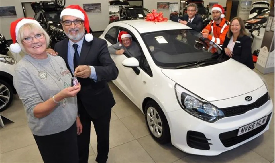 Jennings Motor Group managing director, Nas Khan, hands raffle prize winner Kath Mewse the keys to her new Kia Rio