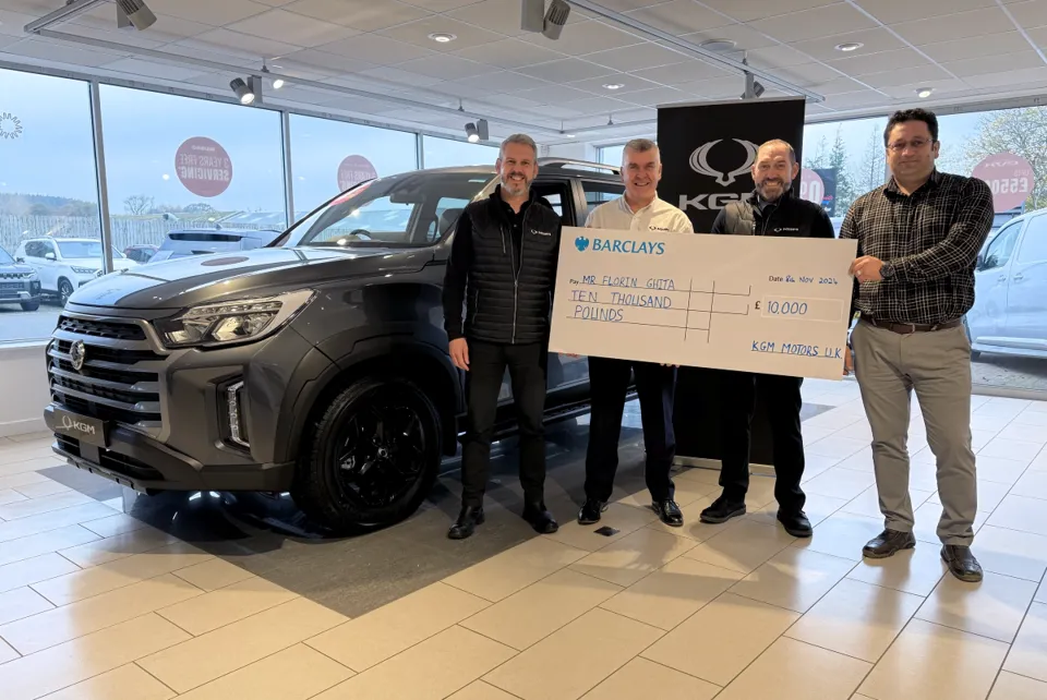 Mr Florin Ghita receiving his check at Kerr and Smith, KGM’s trusted dealer partner in Cumnock, East Ayrshire, Scotland