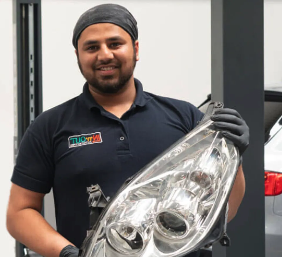 A technician holding a Certified Recycled part